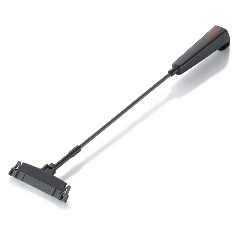 Black tool with a long handle on a white background